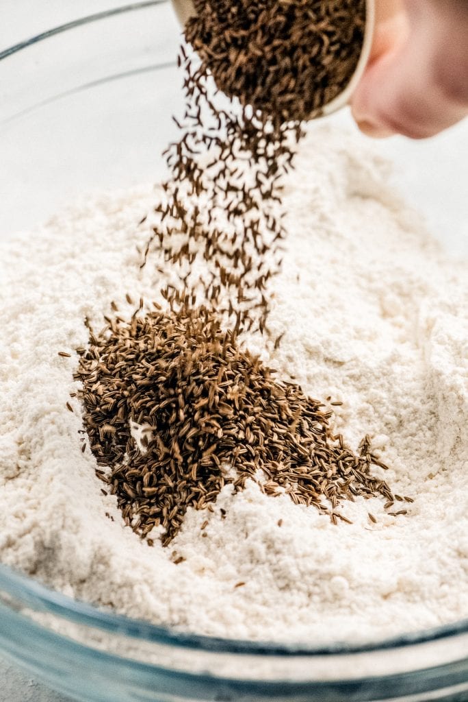 caraway seeds sprinkled into flour mixture