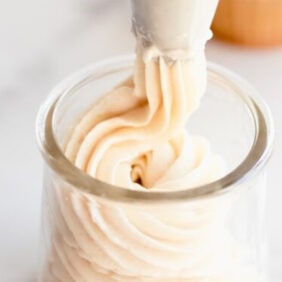 buttercream frosting piped into a glass jar