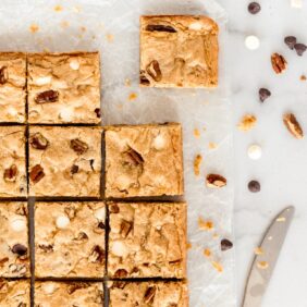 blondies cut into squares with chocolate chips and pecans