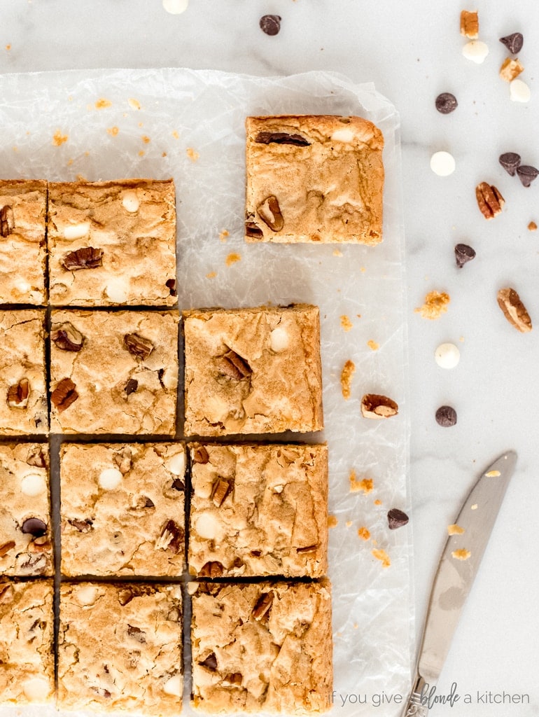 blondies cut into squares with chocolate chips and pecans