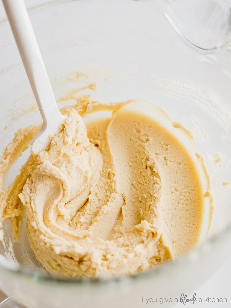 glass mixing bowl of sugar cookie dough with spatula