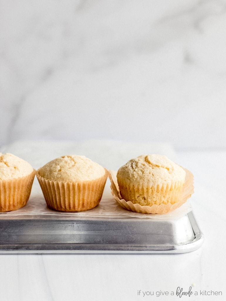 muffins on baking sheet with paper liner unwrapped