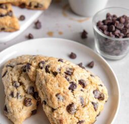 two chocolate chip scones on white round plate