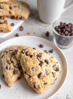 two chocolate chip scones on white round plate