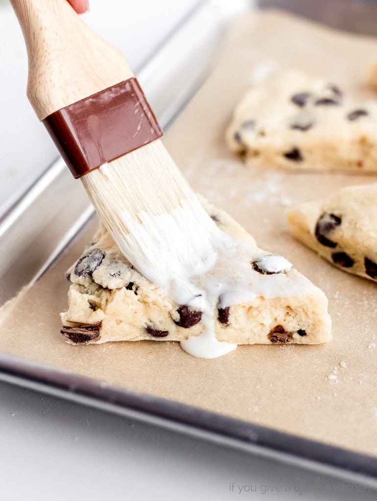 pastry brush coating scones in heavy cream
