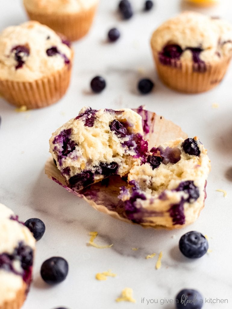 blueberry muffin cut in half with juice blueberries inside