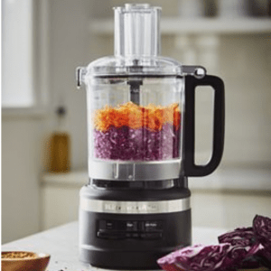 food processor with red cabbage and carrots inside