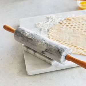 marble rolling pin on work surface with dough