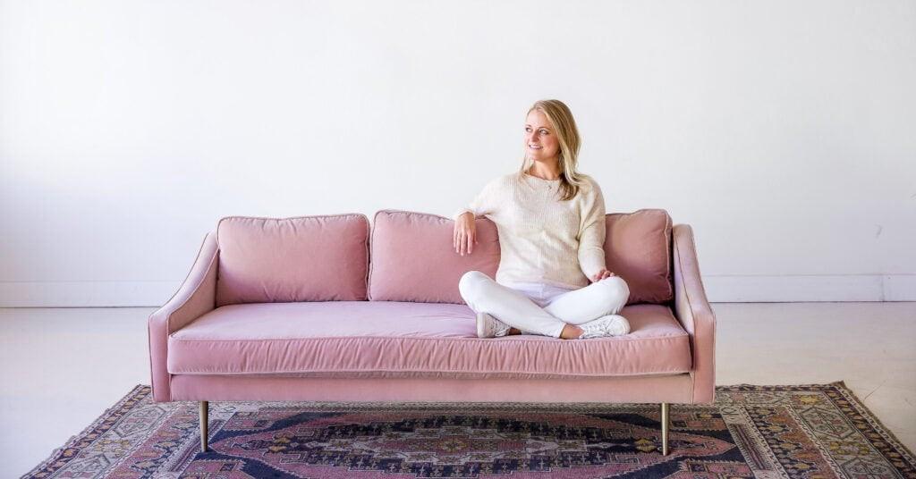 haley blonde sitting on pink sofa