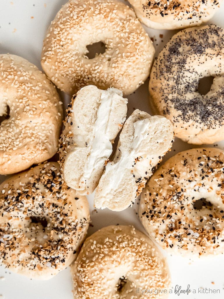 homemade bagels with center bagel cut open with cream cheese