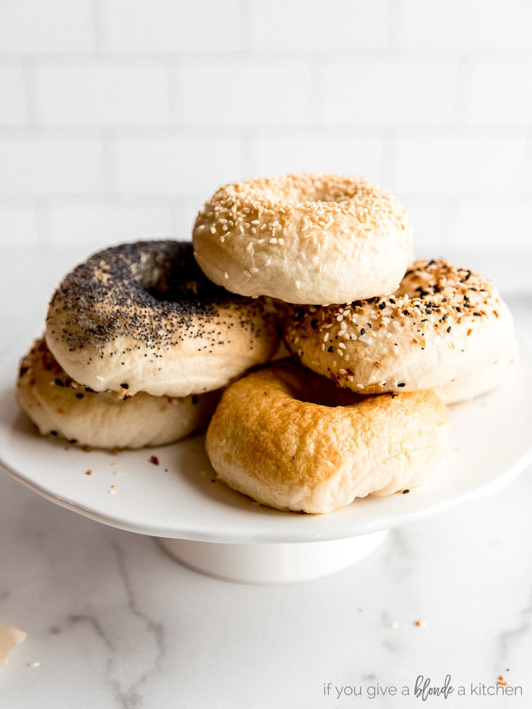 homemade bagels on white cake stand