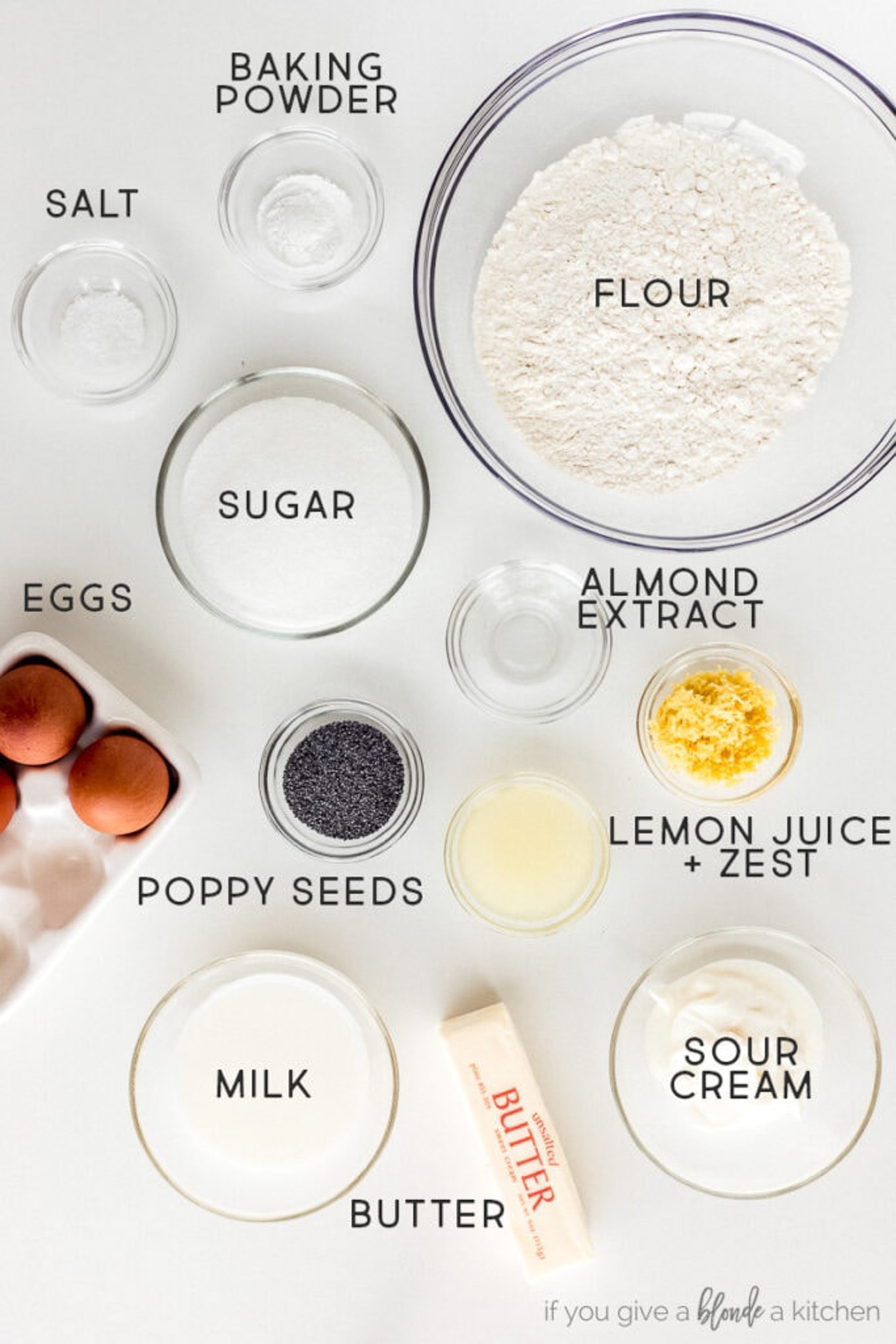 lemon poppyseed bread ingredients in bowls labeled with text.