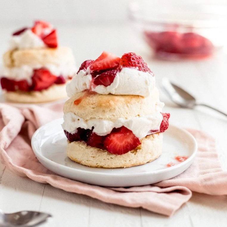 layered strawberry shortcake on a white round plate