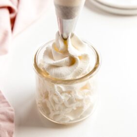 whipped cream piped into a glass jar
