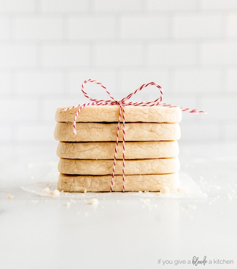stack of rectangle shortbread cookies tied up with red bakers twine