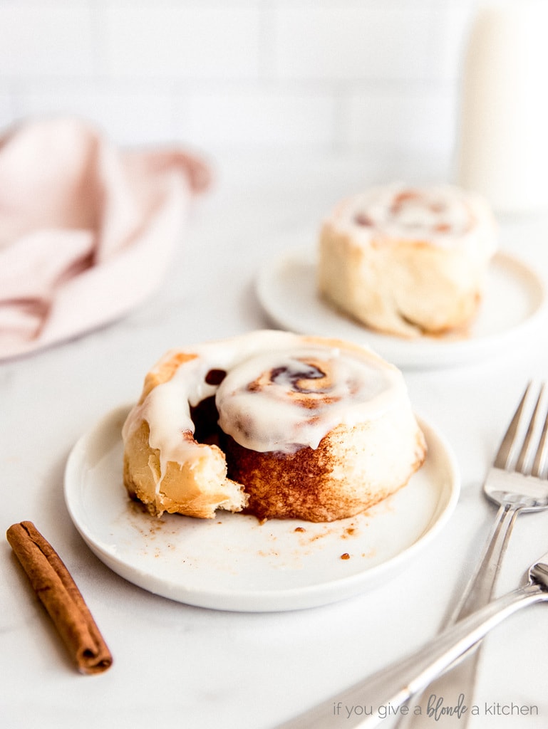 cinnamon roll slightly pulled apart showing brown sugar filling; cream cheese icing on top