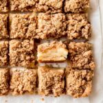 apple crisp bars cut into square with one turned on its side to show apple layers