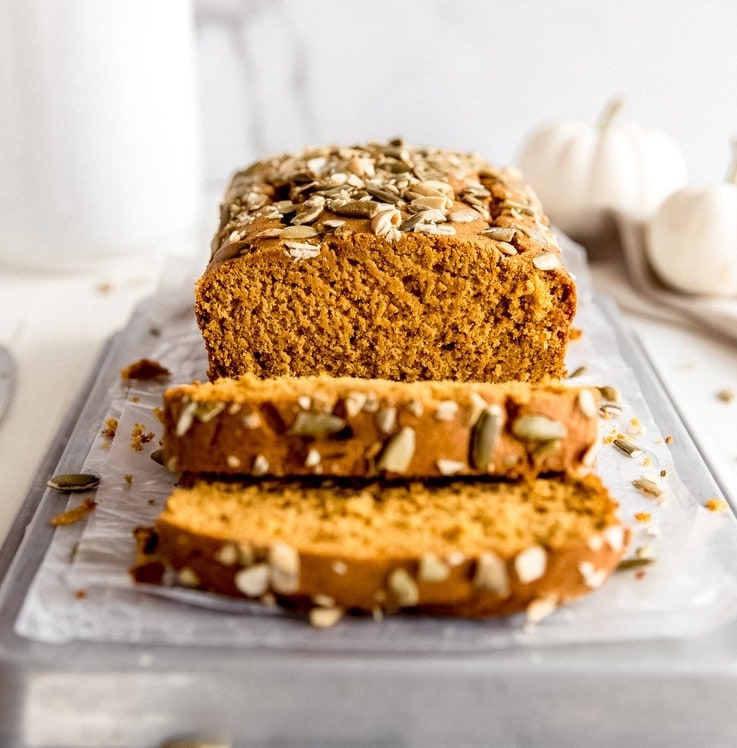 pumpkin bread with slices in front cut off loaf