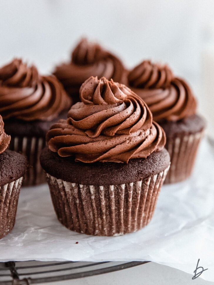 chocolate buttercream frosting on top of chocolate cupcakes