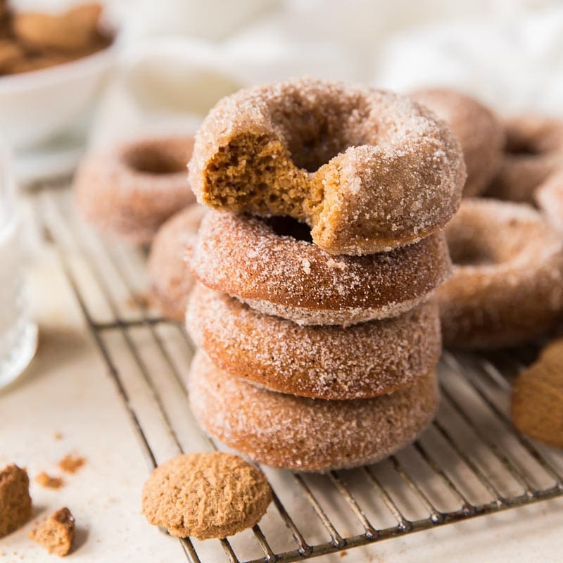 stack of abked gingerbread donuts; top donut with a bite
