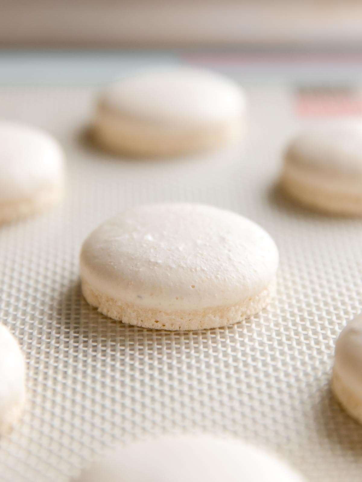 perfectly baked macaron with feet on silpat mat
