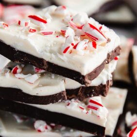 stack of homemade peppermint bark showing layers of dark chocolate and white chocolate