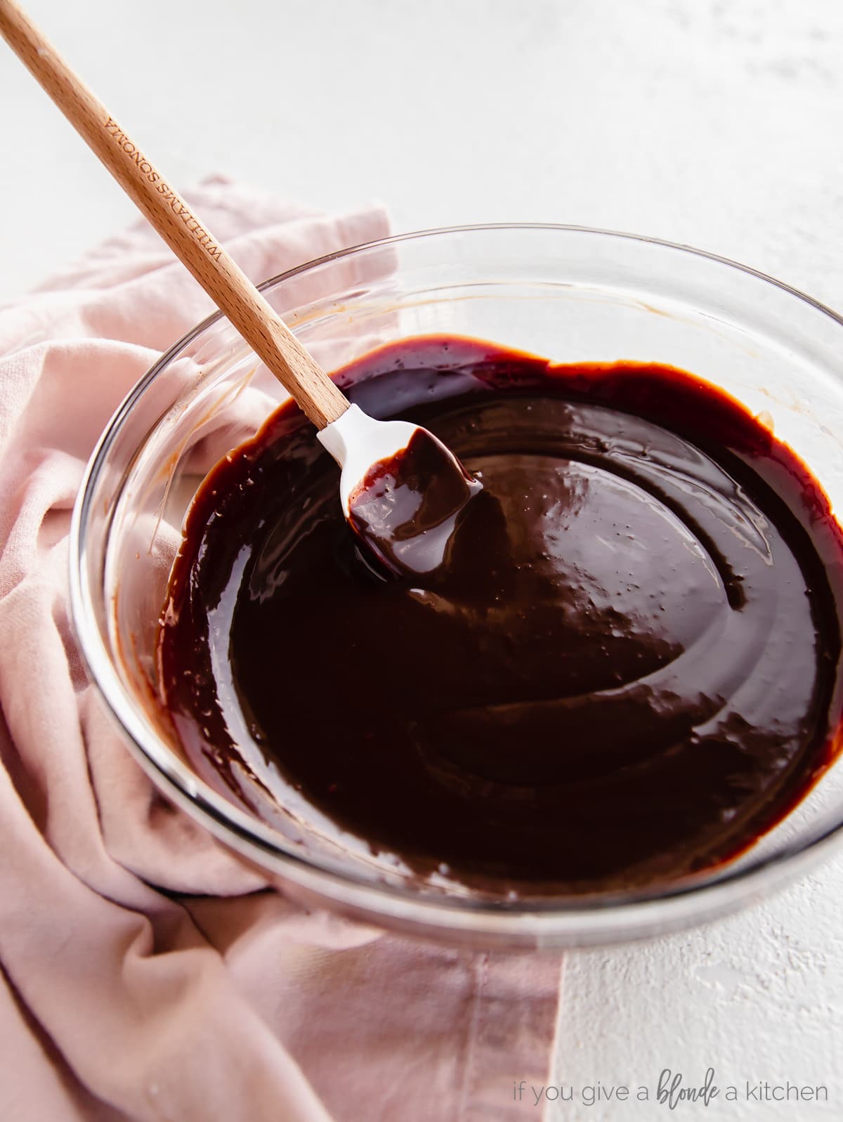 glass bowl of chocolate ganache with mini rubber spatula