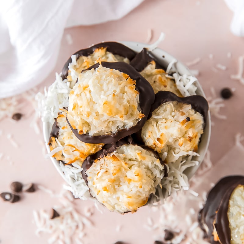 coconut macaroon cookies with chocolate bottoms in a small bowl.