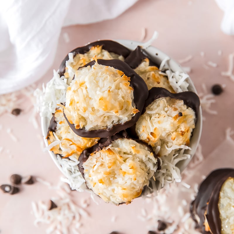 coconut macaroon cookies with chocolate bottoms in a small bowl