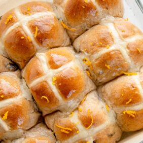 hot cross buns with glossy glaze and orange zest on top