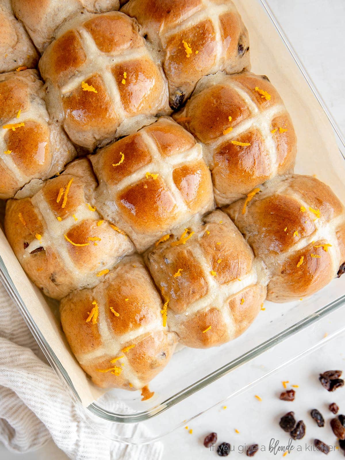 hot cross buns with orange zest in a glass baking dish
