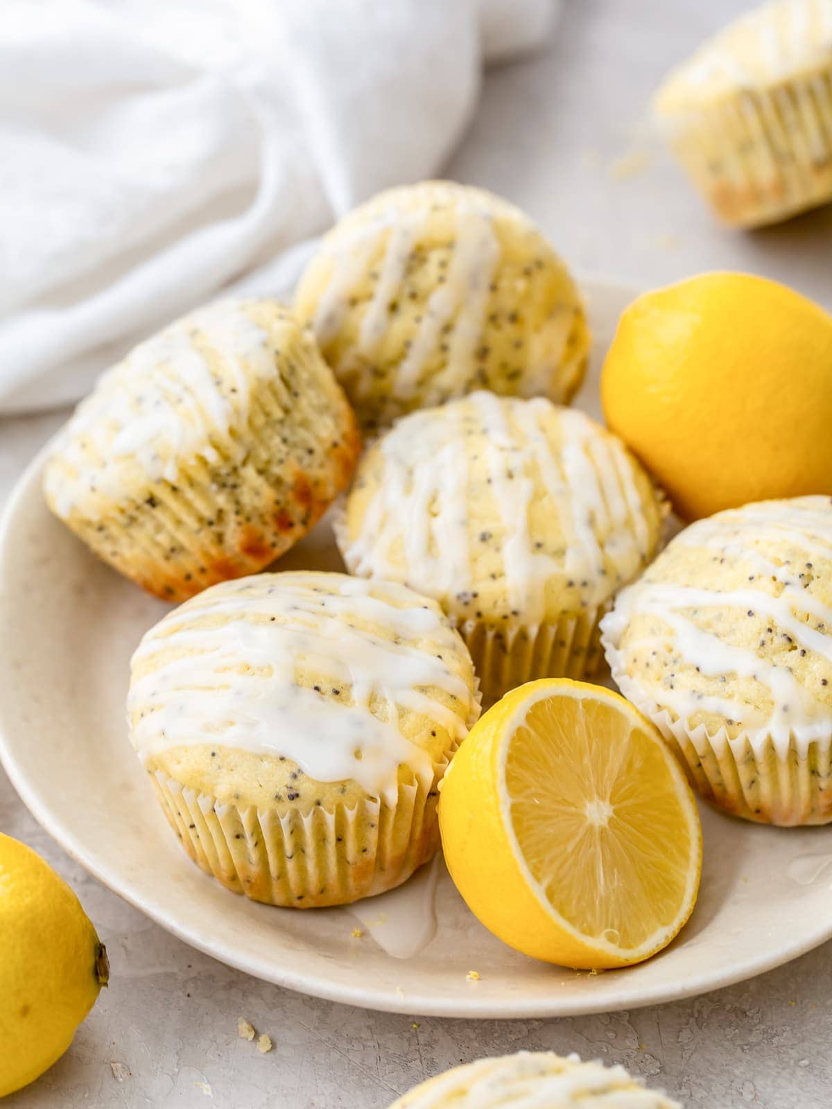 plate of lemon poppy seed muffins with glaze