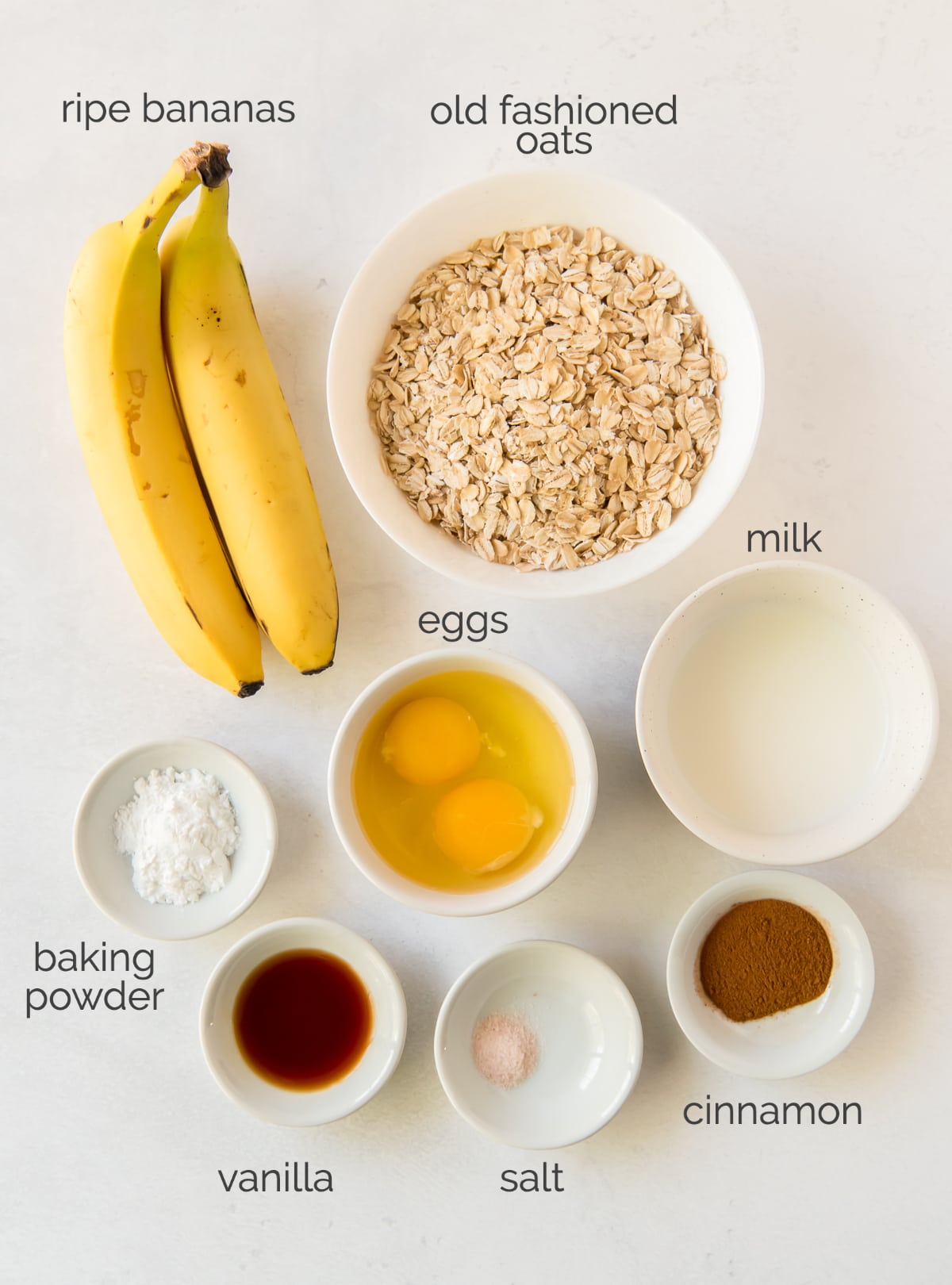 banana oatmeal pancakes ingredients in bowls.