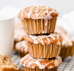 stack of three coffee cake muffins with streusel and icing