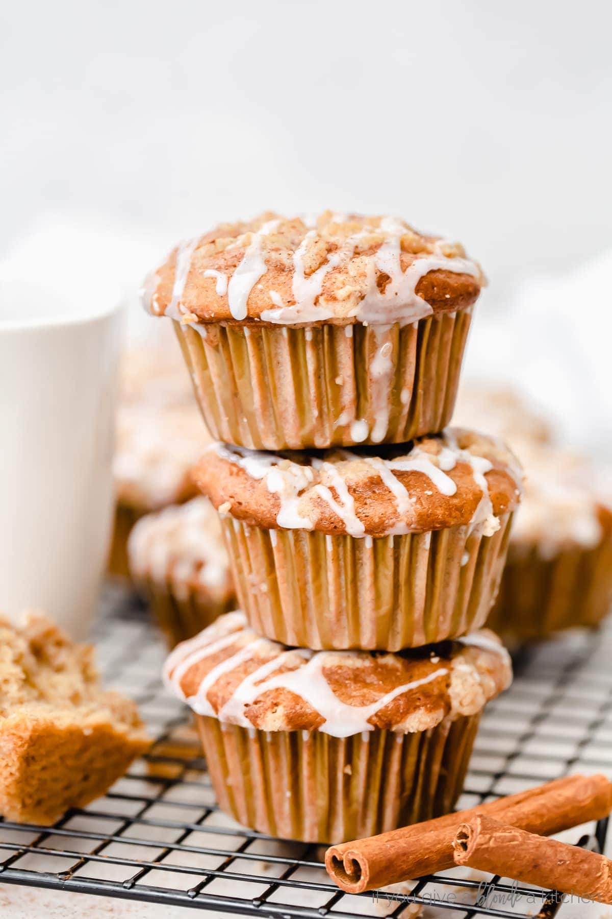 stack of three coffee cake muffins with streusel and icing