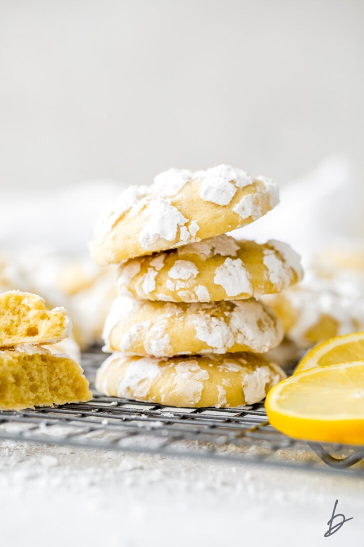 stack of four lemon crinkle cookies with confectioners' sugar