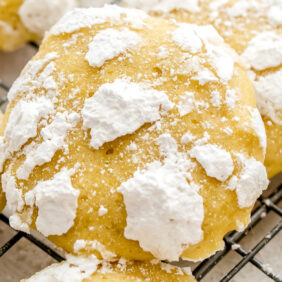 lemon crinkle cookie propped up on more cookies