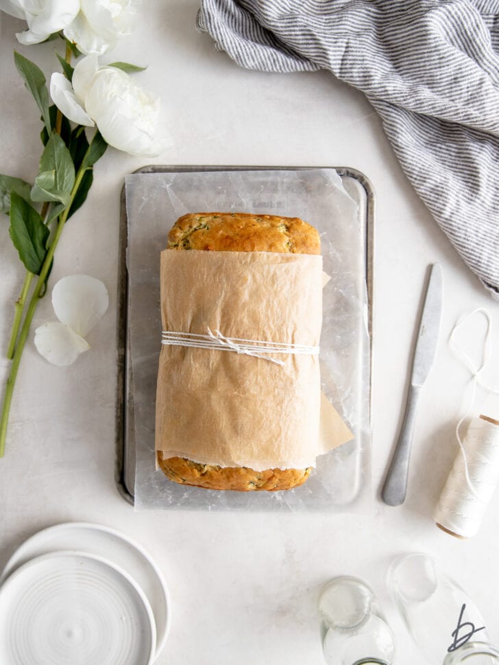 zucchini banana bread wrapped in parchment paper and tied with baking string