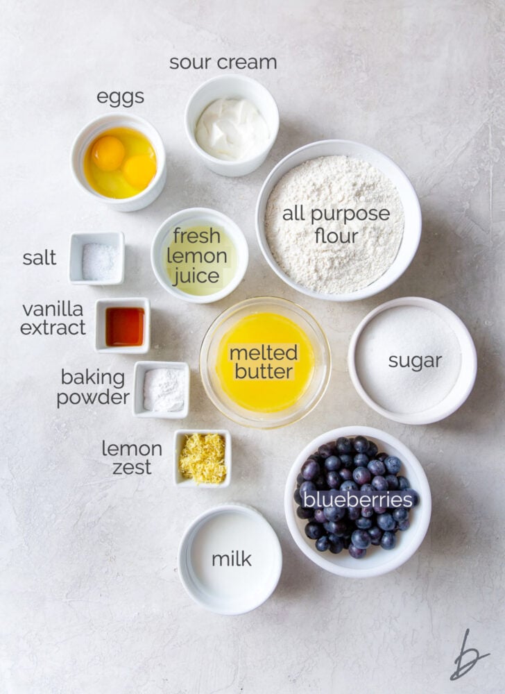 lemon blueberry bread ingredients in bowls labeled with text