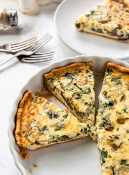 slices of quiche in a ceramic quiche dish