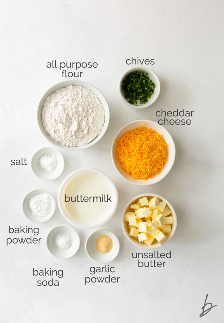 cheddar biscuit ingredients in bowls labeled with text