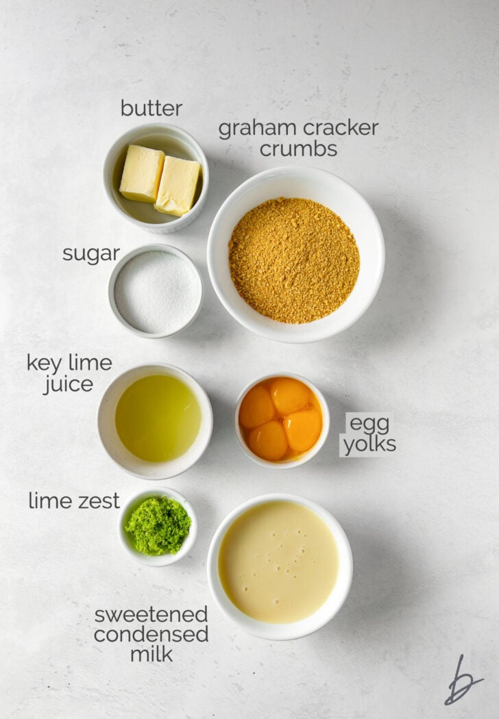 key lime pie bar ingredients in bowls labeled with text