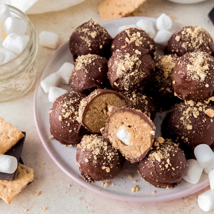 smores truffles on plate with one truffle cut in half to show mini marshmallow inside