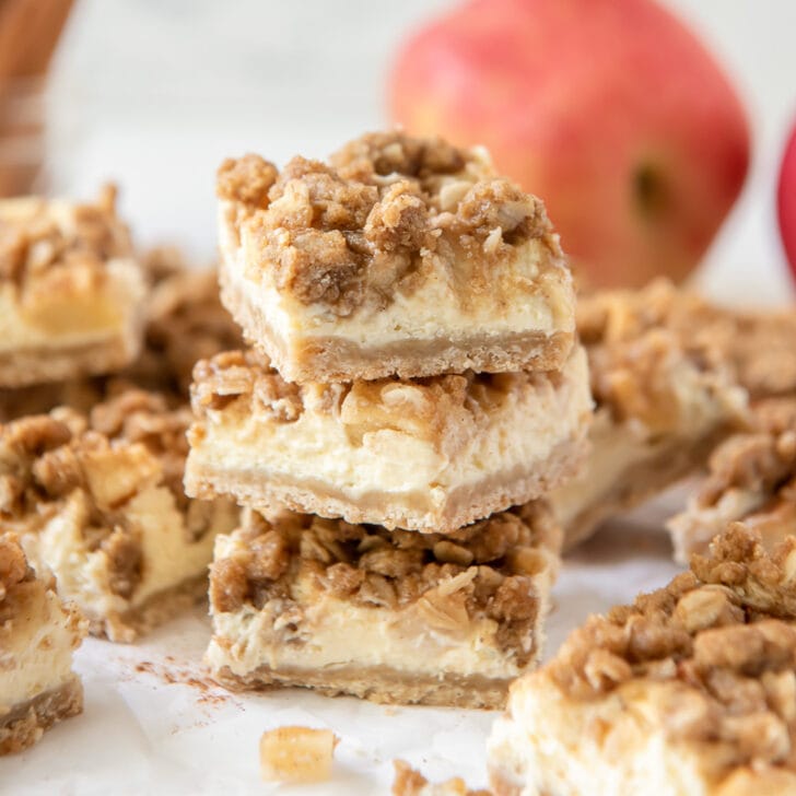 stack of three apple cheesecake bars with crumble topping