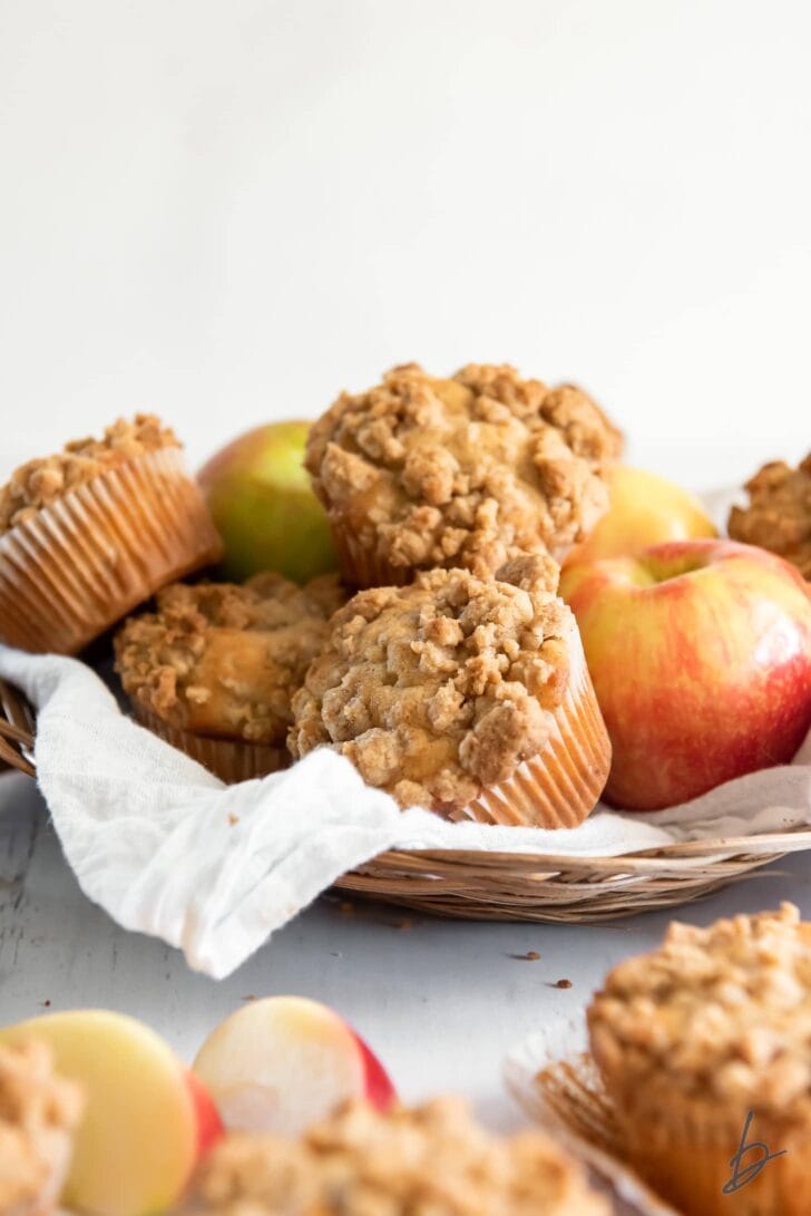 basket of apple crumble muffins and honey crisp apples