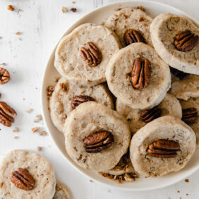 plate of pecan sandies topped with pecan halves