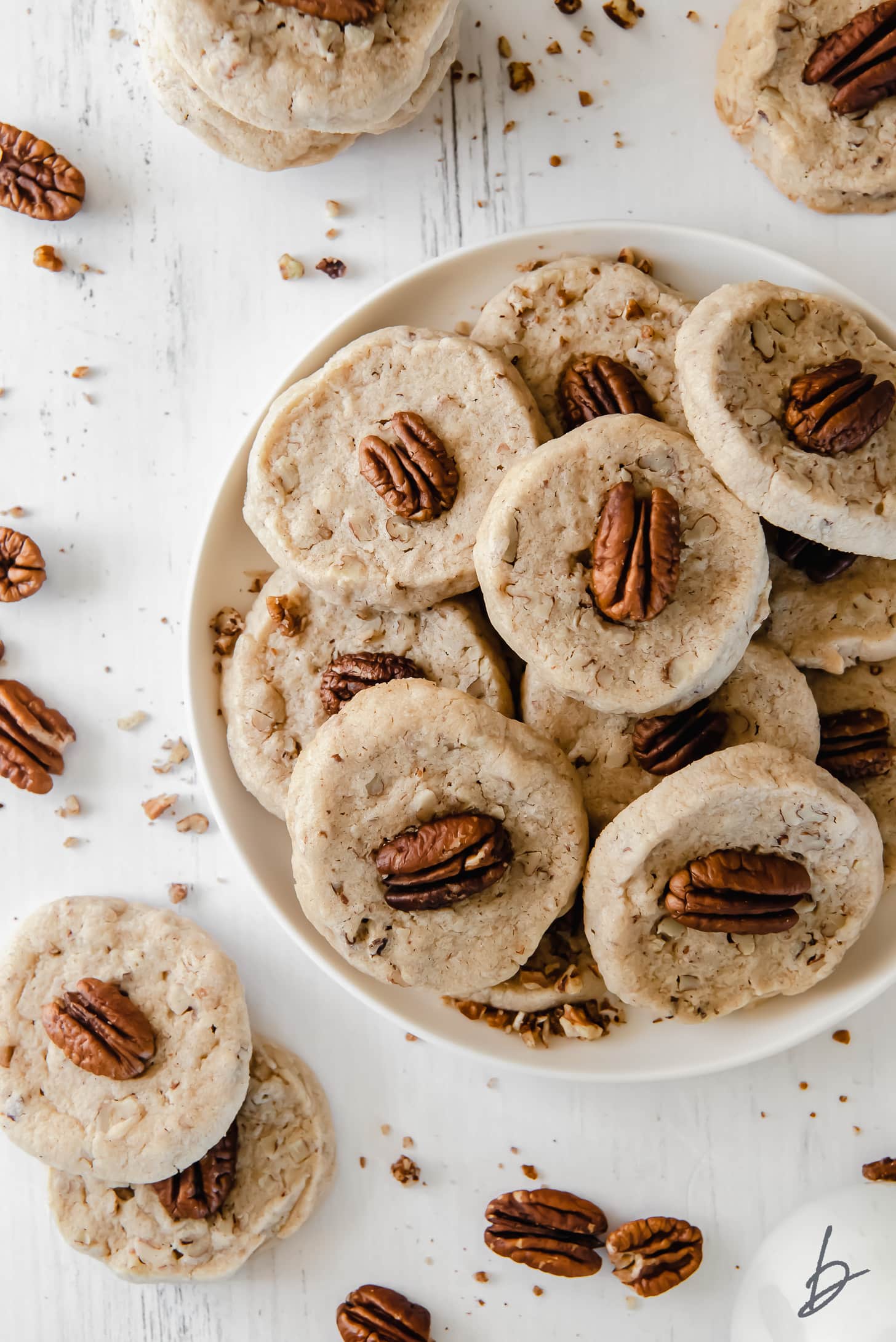 plate of pecan sandies topped with pecan halves