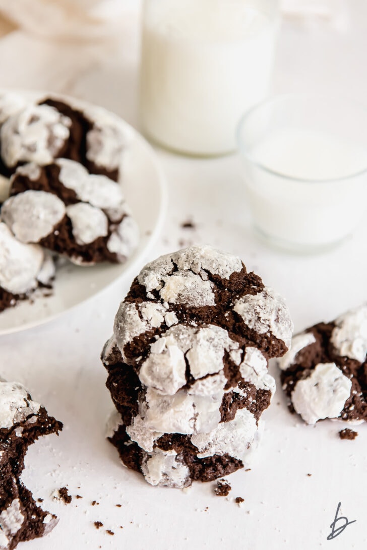 stack of chocolate crinkle cookies covered in powdered sugar