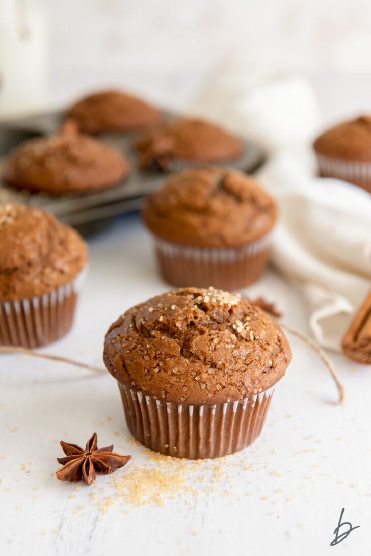 gingerbread muffin with coarse sugar on top next to baking twine and anise star