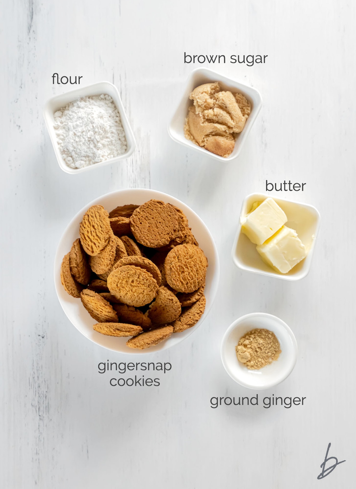 Gingersnap crust ingredients in bowls labeled with text.